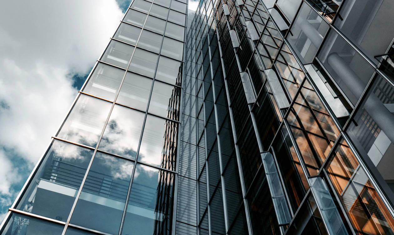 Glass office building reflecting the sky